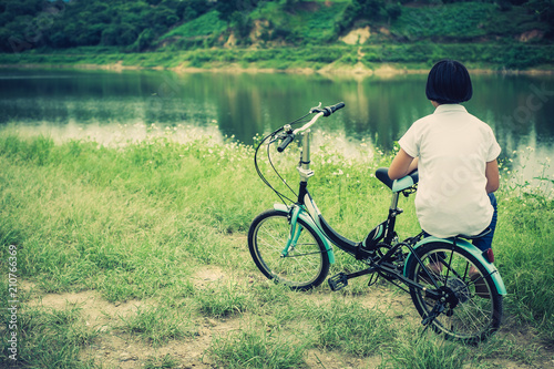 Young Asian girl with vintage bicycle in countryside nature landscape.