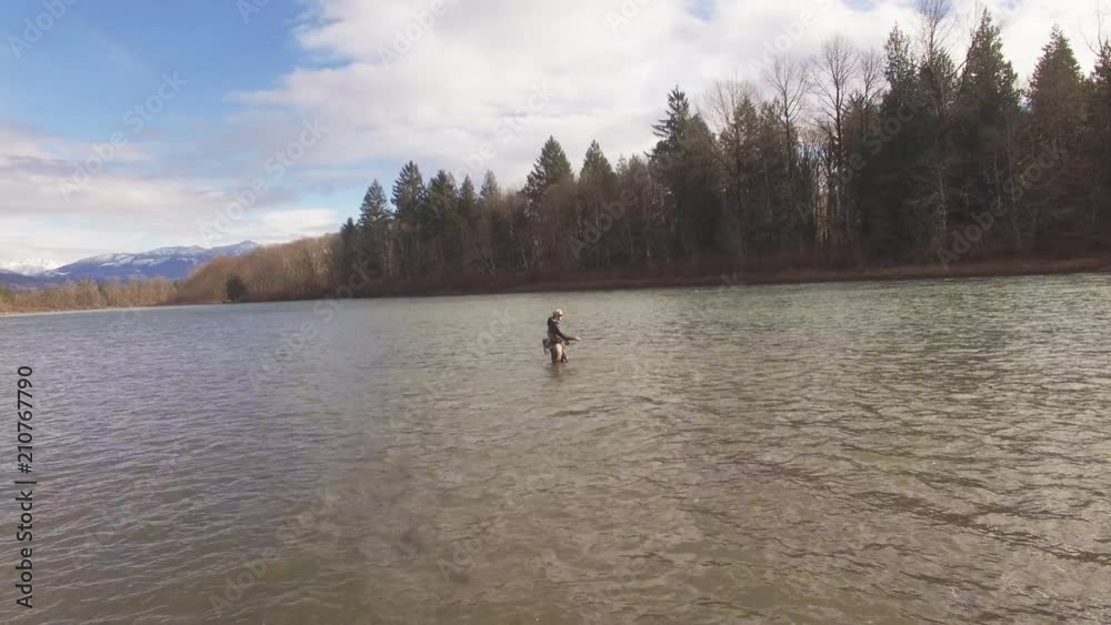 Man fishes in Washington river, aerial Man fishes in Washington river, aerial