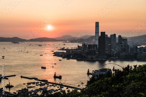 Stunning view of the sunset above the Victoria harbor in Hong Kong with the skyscraper of Kowloon Tsim Sha Tuis waterfront in the left in China
