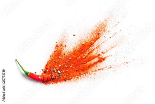 Fototapeta Naklejka Na Ścianę i Meble -  Chili powder and flakes burst out from red chili pepper
