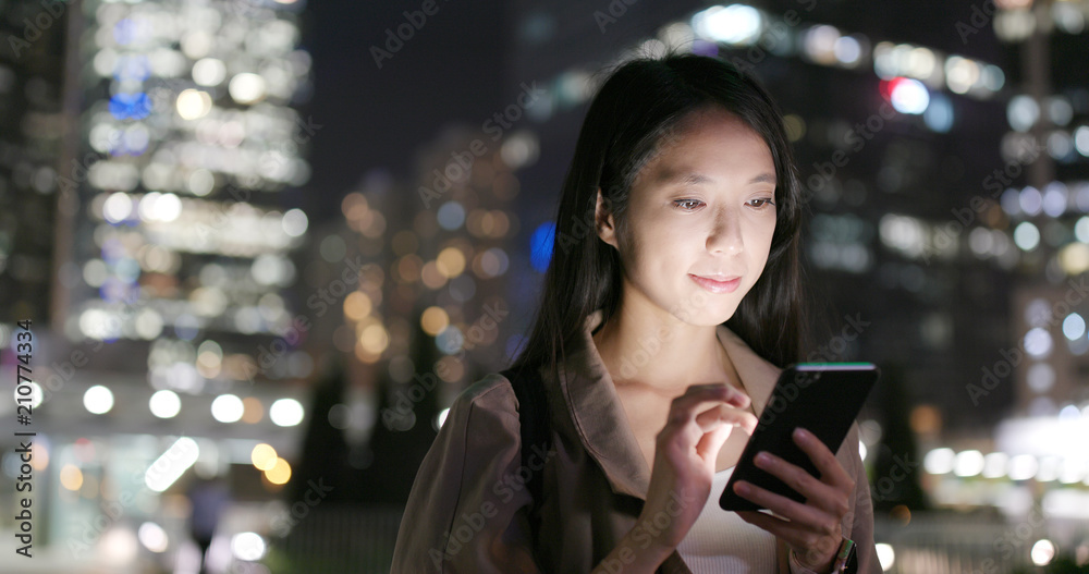 Woman use of mobile phone at night Woman use of mobile phone at night