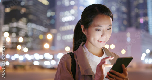 Photography Business woman look at smart phone in city at night