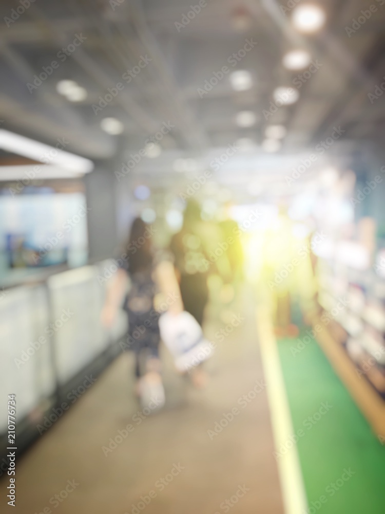 Abstract background of blurred image of people in shopping mall with bokeh. Vintage tone. for background usage