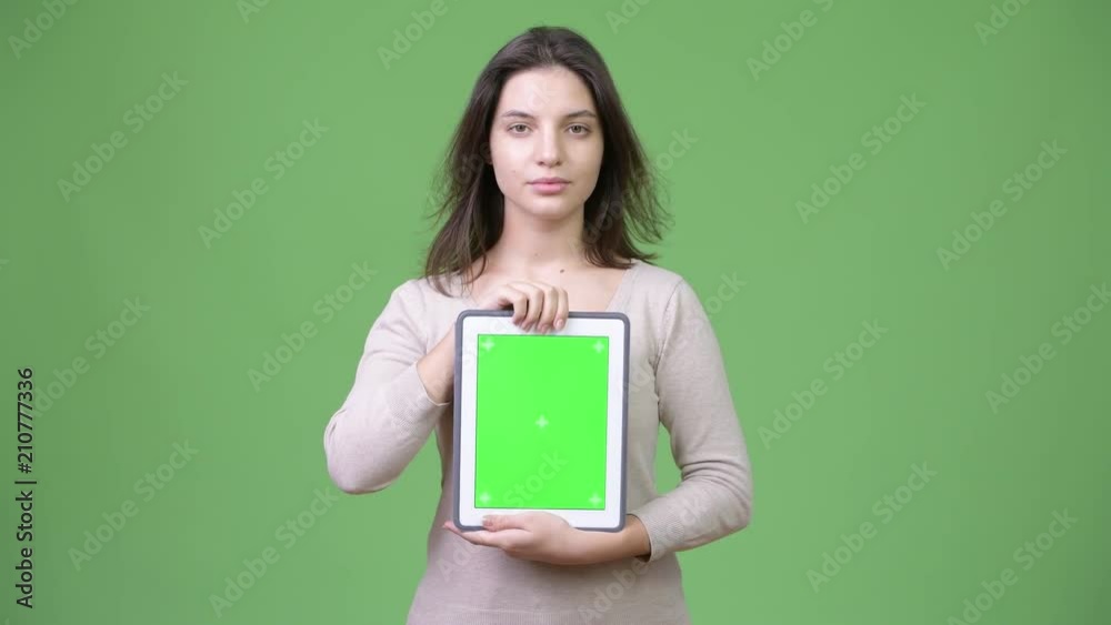 Young beautiful woman showing digital tablet Young beautiful woman showing digital tablet
