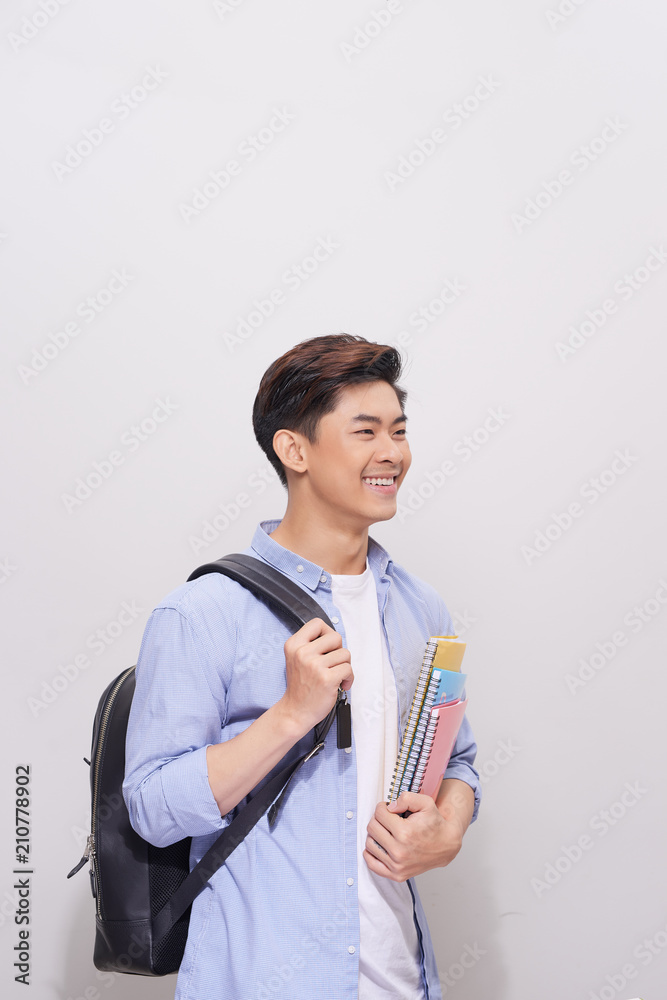 Confident asian handsome student holding books Confident asian handsome student holding books