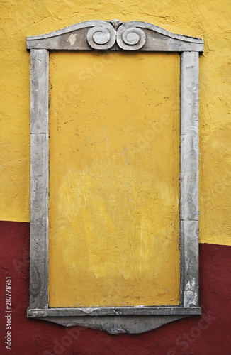 Rustic Colonial mexican street empty frame, stone frame yellow and red wall.