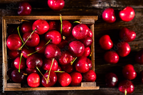 Fresh sweet cherries in a wooden box top view photo
