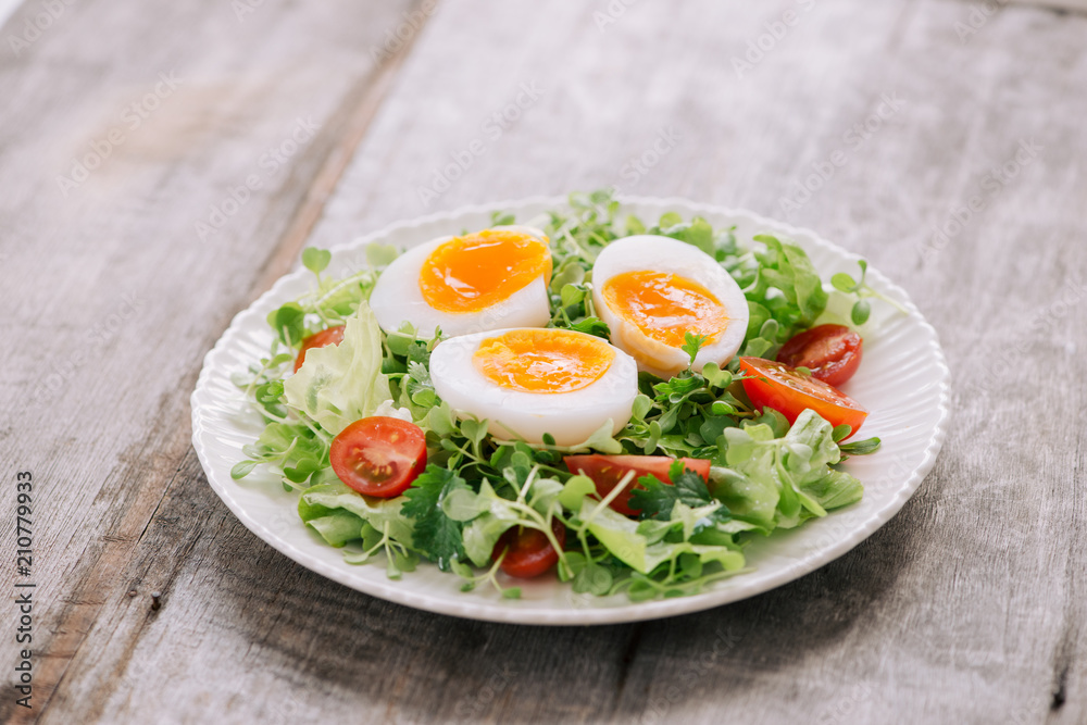 Lambs lettuce salad, hard-boiled eggs, tomatoes and honey mustard dressing Lambs lettuce salad, hard-boiled eggs, tomatoes and honey mustard dressing