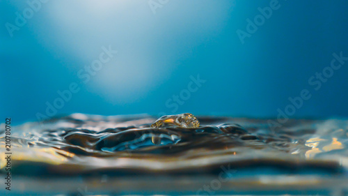 Set of splash photography  drops falling into the water in a blue lighted background  isolated drop and or multiple water drops.