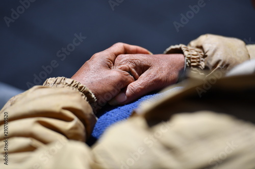 Hand in hand. A retiree sits on a bench in Montreal Canada on a warm and sunny spring day
