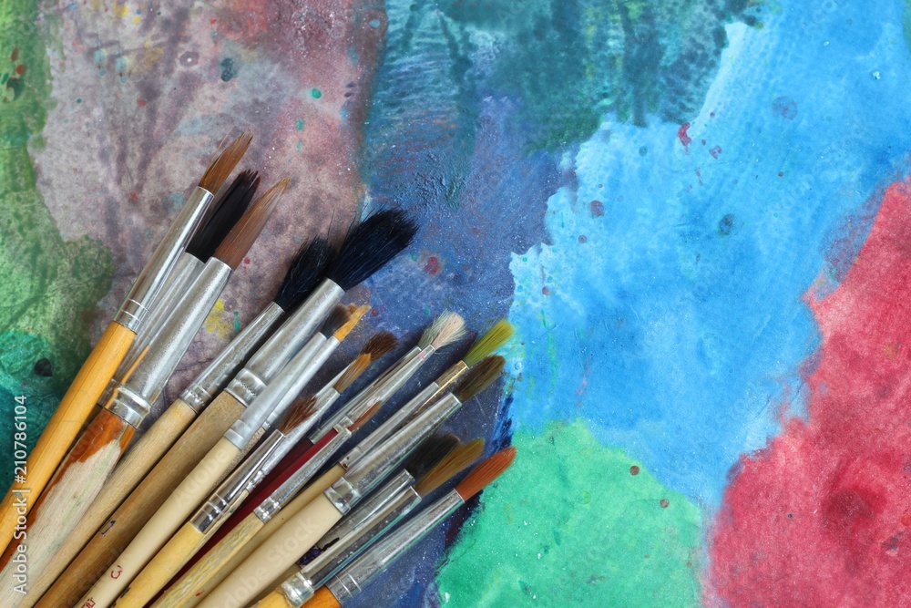 Fototapeta premium Paintbrush on painted abstract background