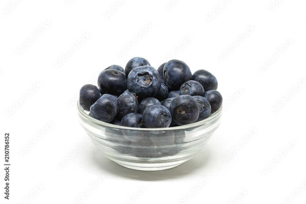 Bilberry in the transparent bowl on the center of the white background Bilberry in the transparent bowl on the center of the white background