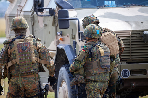 German soldiers stands near military vehicles on a open day on day of the Bundeswehr in Feldkirchen