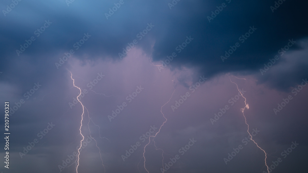 The discharge of lightning in the sky as a background The discharge of lightning in the sky as a background