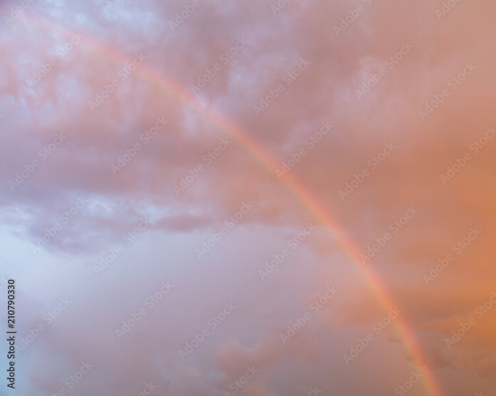 Rainbow in the sky at sunset as background