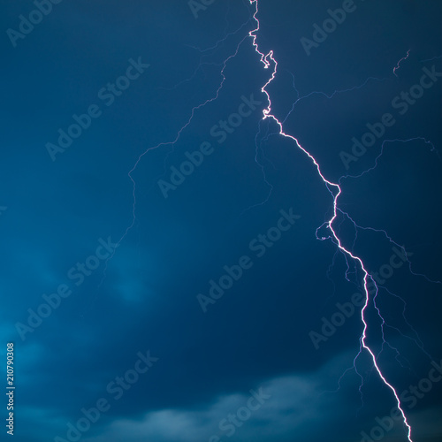 The discharge of lightning in the sky as a background