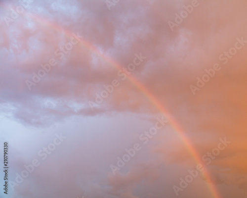 Rainbow in the sky at sunset as background © schankz