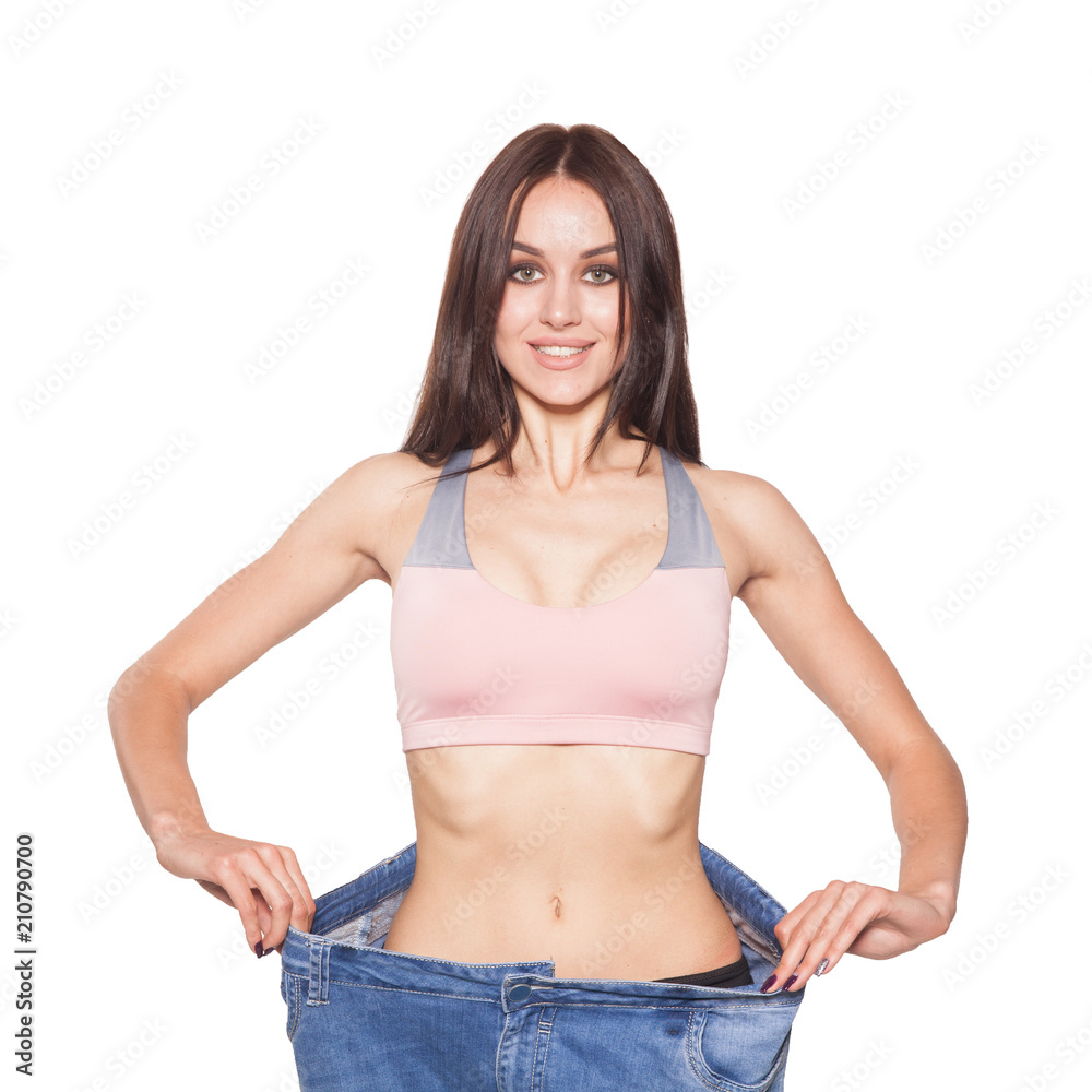 A beautiful brunette model in sportswear shows the results of losing weight. Relief abdomen. A beautiful brunette model in sportswear shows the results of losing weight. Relief abdomen.