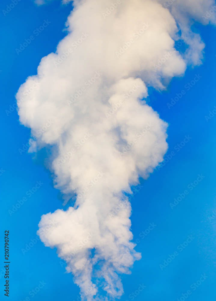 smoke from a pipe in the factory against a blue sky smoke from a pipe in the factory against a blue sky