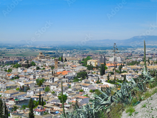 Albaicin  Old muslim quarter  white houses with orange tiling roofs  district of Granada in Spain. View from the top of Sacromonte mountain. Panorama.