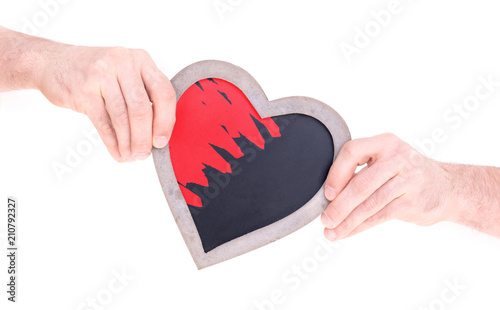 Adult holding heart shaped chalkboard