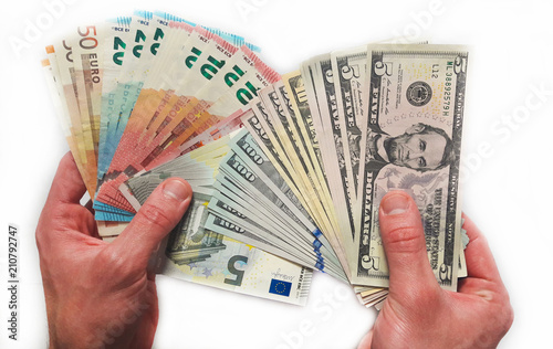 Closeup hands giving euro and dollars money isolated on white background