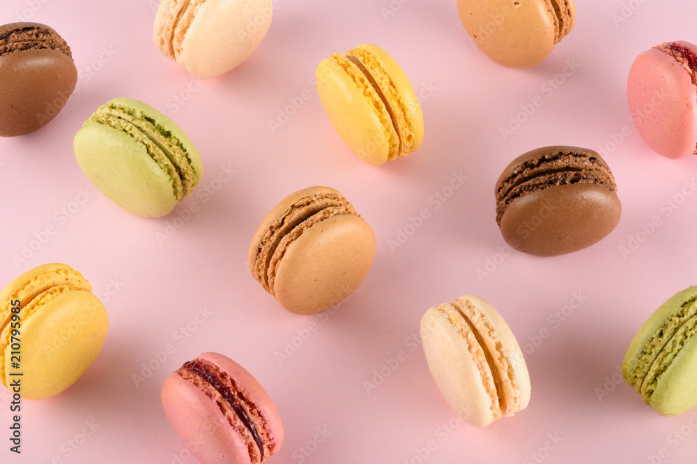 Obraz premium Original classic colorful french macarons assortment with different tastes on pink pastel background