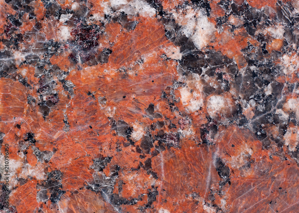 Granite texture. Reddish-brown base with black and gray spots. Used as a background. Granite texture. Reddish-brown base with black and gray spots. Used as a background.