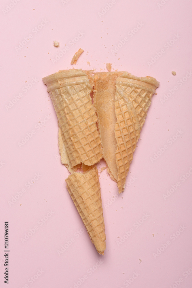 Crushed ice cream waffle cone on pink pastel background