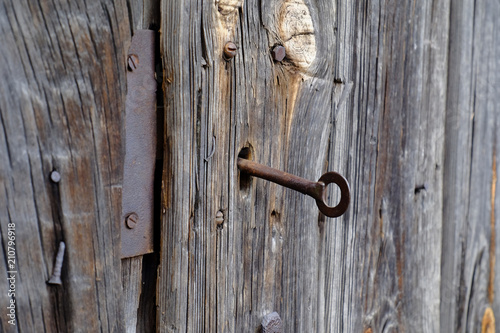old wooden door with a rusty key © Olexandr