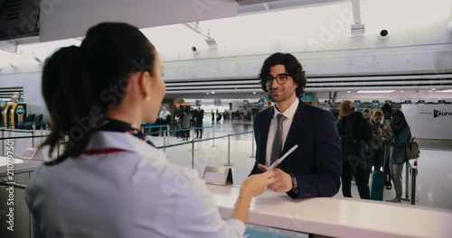 Young businessman doing check-in at airport before international business travel photo