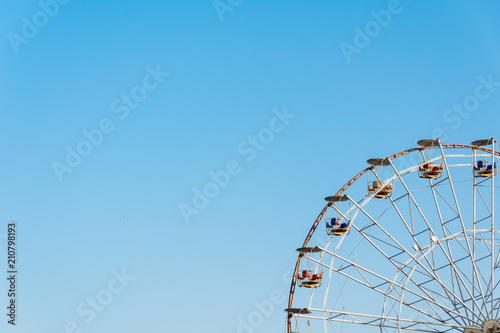 Ferris wheel on blue sky background