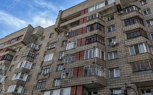 Soviet apartment building. Apartment block. Residential building. Soviet architectural style. 1980s. Blue sky. Ust-Kamenogorsk (Kazakhstan)