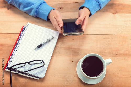 Girl with a mobile phone and stationery.