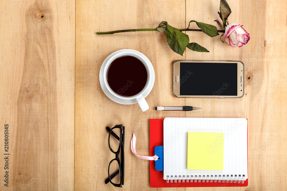 Mobile phone, glasses, cup of tea, flowers, stationery