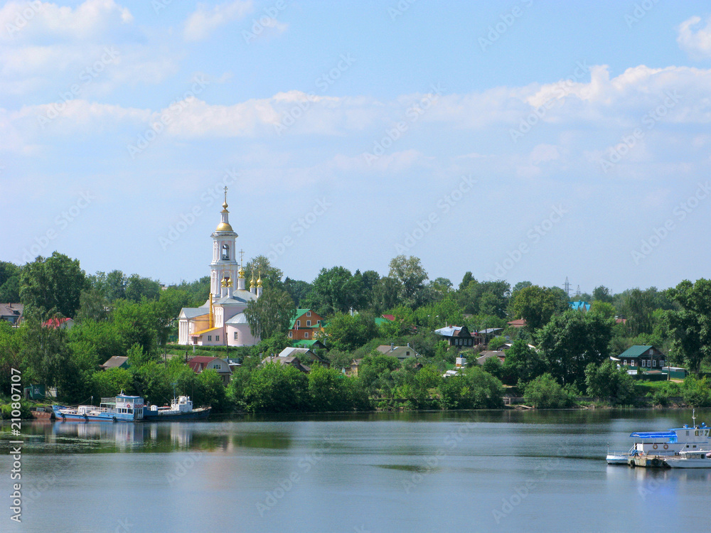 Small towns of Russia. Kimry, Tver region. Panorama of the city with Lord's ascension temple and wooden houses on the bank of the Volga river.