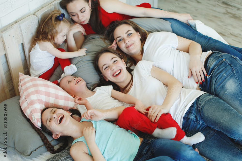 Girls with pigtails and a younger brother smile and laugh. The concept of a happy family. Girls with pigtails and a younger brother smile and laugh. The concept of a happy family.