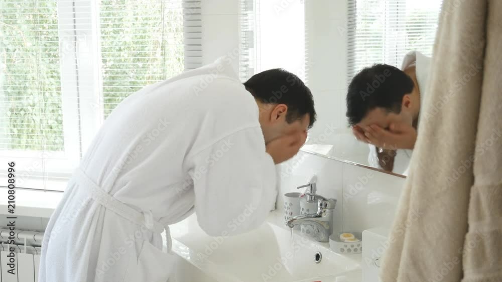 Guy washes in the bathroom Guy washes in the bathroom