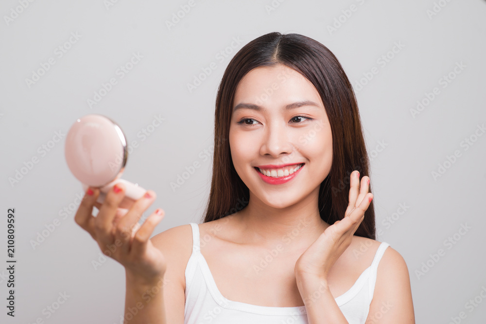 Portrait of beautiful asian woman checking powder makeup of cosmetic, beauty of girl with face smile isolated on white background, wellness and healthcare concept. Portrait of beautiful asian woman checking powder makeup of cosmetic, beauty of girl with face smile isolated on white background, wellness and healthcare concept.