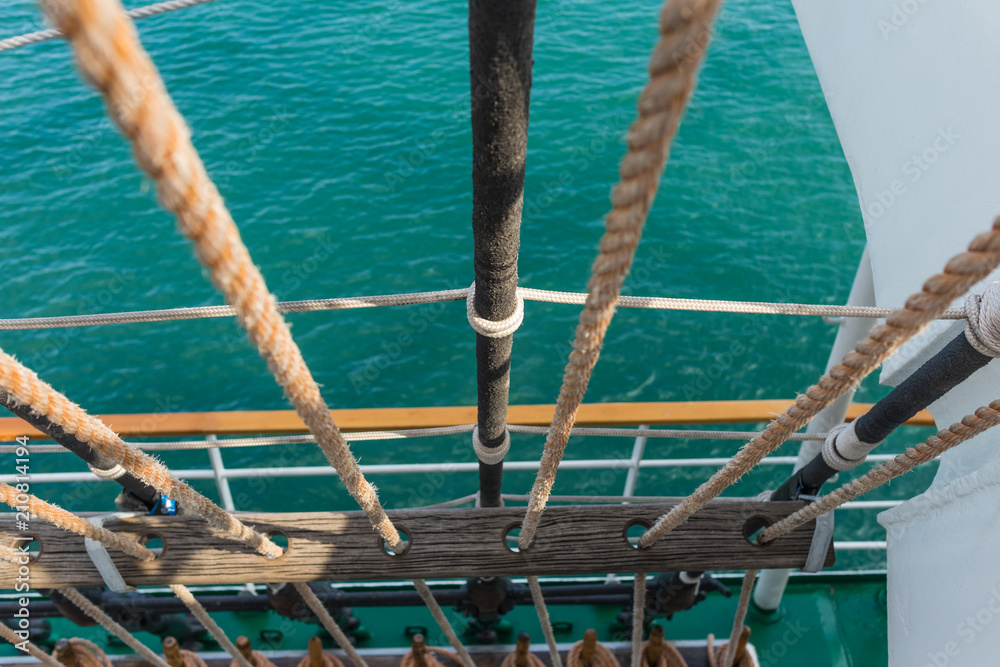 Naklejka premium Rigging and part of the deck of a sailing vessel close-up against a background of sea water, top view