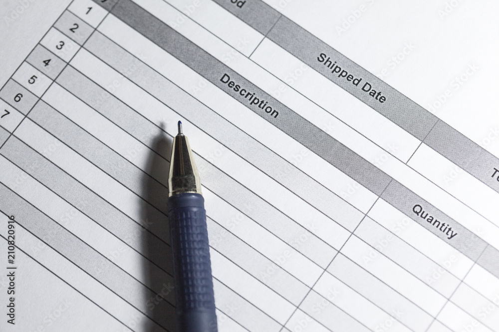 Purchase order. Macro photo of purchase order with pen. Close up purchase order with blue pen in the office.