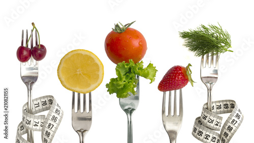 Diet Concept, fresh and healthy vegetables and fruit on the fork isolated on whtie background