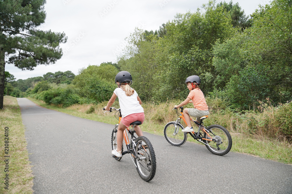 Kids with parents riding bikes in countryside Kids with parents riding bikes in countryside