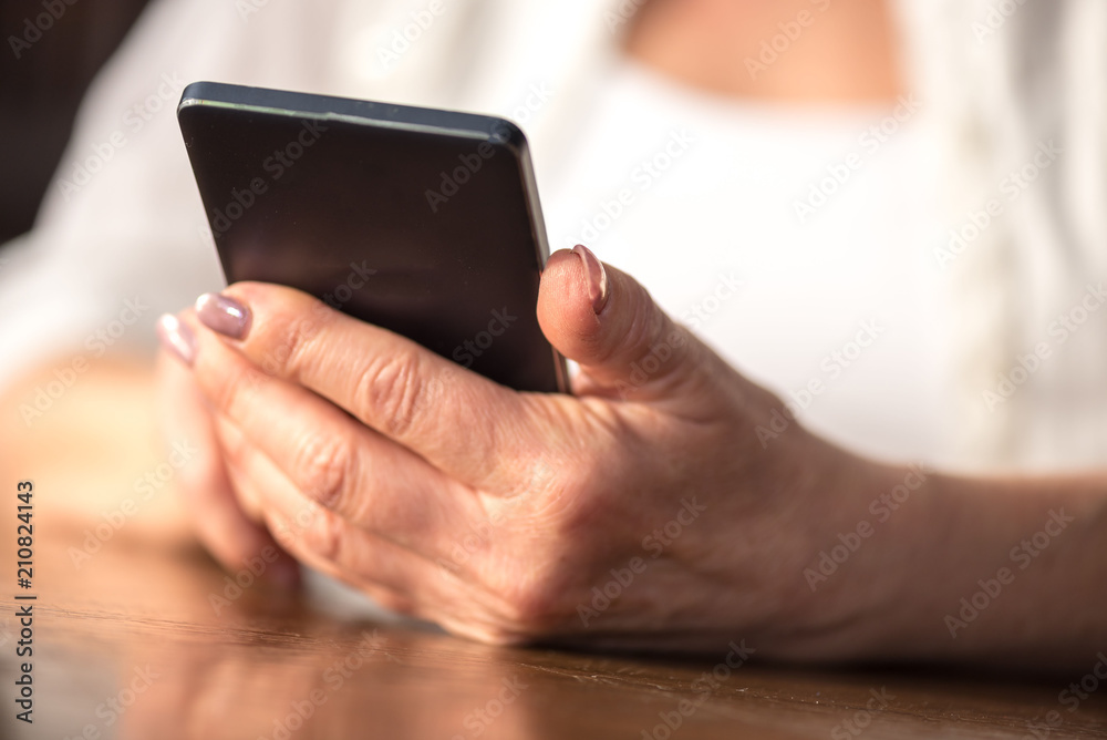 Woman's hands using a mobile phone