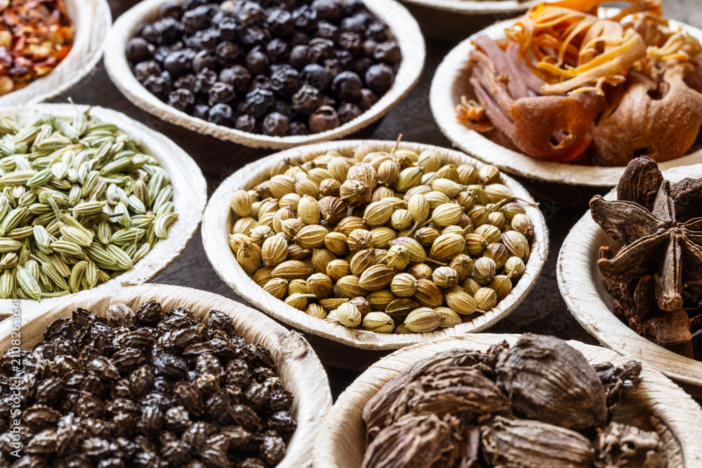 Group of indian spices in coconut bowls on wooden background Group of indian spices in coconut bowls on wooden background