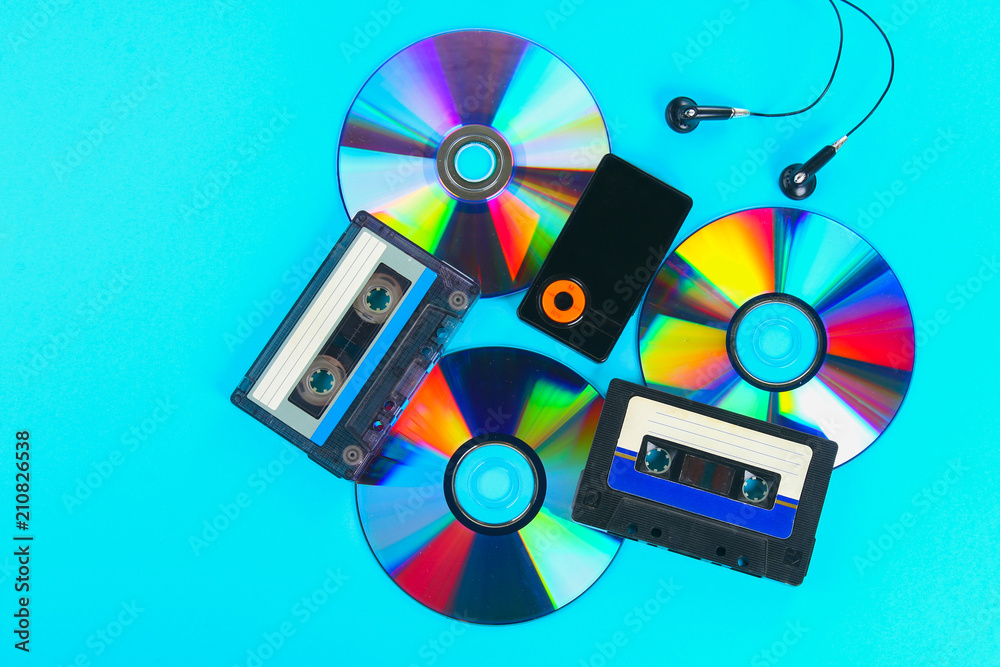 The concept of the evolution of music. Cassette, CD-disk, mp3 player.  Vintage and modernity. Music support. Stock Photo | Adobe Stock