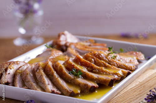 Sliced duck breast with orange sauce and thyme. Duck breast fillets steak photo