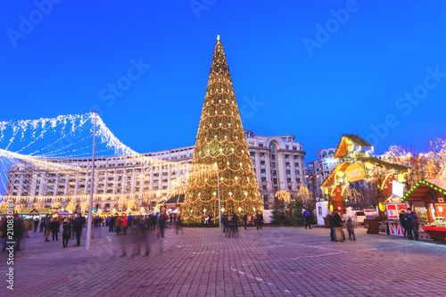 Christmas tree in winter holiday market of Bucharest. People celebrating Christmas outdoor in the main square of the Capital