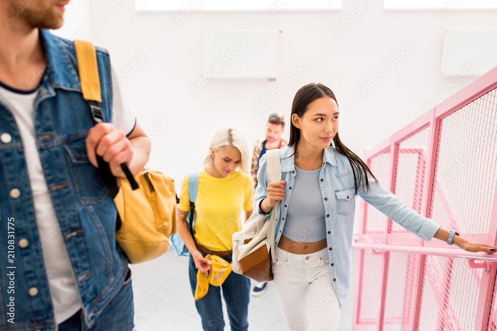 young students on stairs of college corridor young students on stairs of college corridor