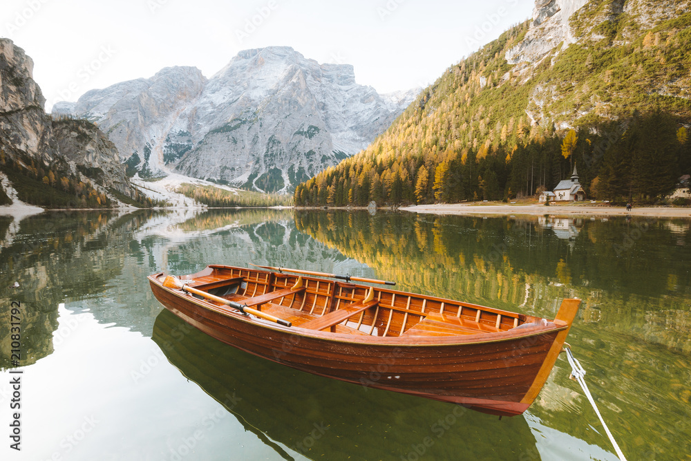 Old rowing boat at Lago di Braies in the Dolomites in fall